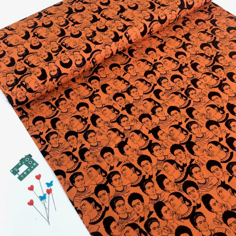 Robert Kaufman Licensed Frida Kahlo Mono Faces Orange (Per Metre)